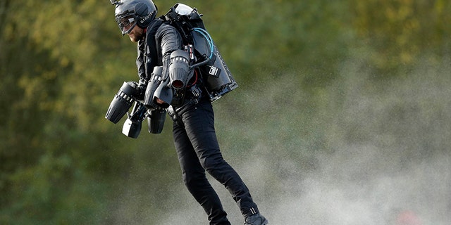 Richard Browning sets the Guinness World Record for 'the fastest speed in a body-controlled jet engine power suit', at Lagoona Park in Reading, England, Thursday, Nov. 9, 2017. A British inventor billed as a real-life version of the superhero Iron Man has hit the fastest speed in a body-controlled jet engine power suit at 32 mph (51 kph) to set a new Guinness world record. The record keeper announced Tuesday's feat on Thursday as part of its annual Guinness World Records day. (Tim Ireland/PA via AP)