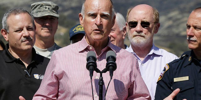Aug 6, 2015: Gov. Jerry Brown, center, speaks next to Mark Ghilarducci, director of the California Governors Office of Emergency Services, left, and Cal Fire Chief Ken Pimlott, right, at a news conference at Cowboy Camp Trailhead near Clearlake, Calif.