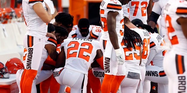 Members of the Cleveland Browns kneel during the national anthem before an NFL preseason football game between the New York Giants and the Cleveland Browns, Monday, Aug. 21, 2017, in Cleveland.