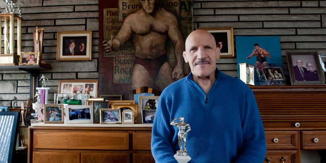 Bruno Sammartino sits in front of pictures, panitings and trophies highlighting his storied career as a wrestler and weightlifter, at his home in his North Hills, Pa., home, March 27, 2013.
