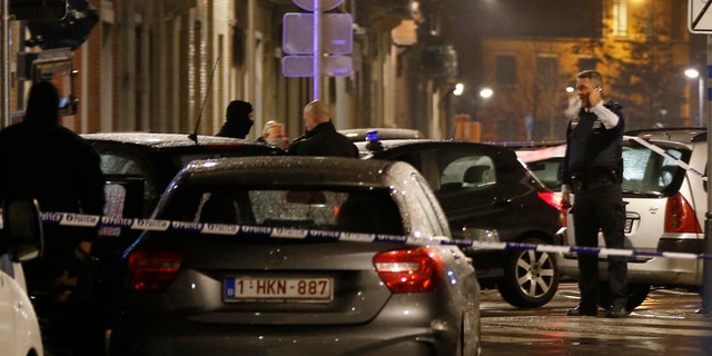 March 25, 2016: Police guard a checkpoint and man positions during a police raid in the suburb of Schaerbeek in Brussels.
