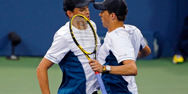 Aug. 30, 2014: Doubles partners Bob Bryan, left, and Mike Bryan of the United States chest-bump to celebrate their victory against Jared Donaldson and Michael Russell, of the United States, during the U.S. Open tennis tournament in New York. (AP)