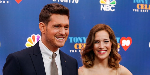 Singer Michael Buble (L) and Luisana Lopilato walk on the red carpet for 