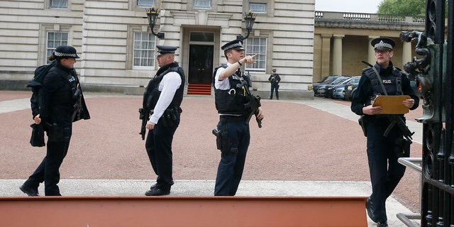 May 19, 2016: Armed police officers work at the main gate of Buckingham Palace in London.