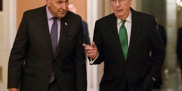 Senate Minority Leader Chuck Schumer, D-N.Y., left, and Senate Majority Leader Mitch McConnell, R-Ky., walk to the chamber after collaborating on an agreement in the Senate on a two-year, almost $400 billion budget deal that would provide Pentagon and domestic programs with huge spending increases, at the Capitol in Washington, Wednesday, Feb. 7, 2018. (AP Photo/J. Scott Applewhite)
