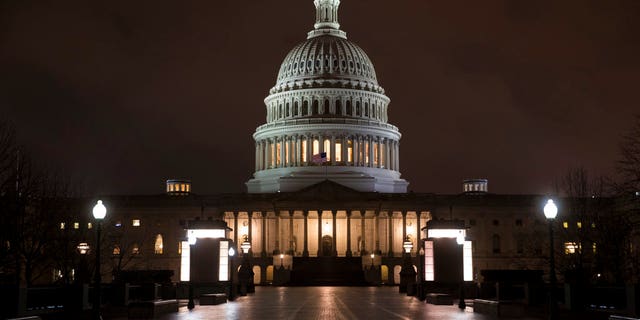 The Capitol is seen before dawn Wednesday after a night of negotiating on the government spending bill, in Washington, March 21, 2018. Talks over a $1.3 trillion omnibus bill are almost complete as the White House and Capitol Hill Democrats ironed out deals on a first round of funding for President Donald Trump's U.S.-Mexico border wall. (AP Photo/J. Scott Applewhite)