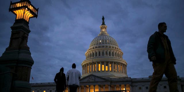In this Jan. 21, 2018, file photo, lights illuminate the U.S. Capitol on second day of the federal shutdown as lawmakers negotiate behind closed doors in Washington. The era of trillion-dollar budget deficits is about make a comeback _ and a brewing budget deal hastened the arrival. Lawmakers are inching closer to a two-year, budget-busting spending pact that would give whopping budget increases to both the Pentagon and domestic programs have been inching closer to an agreement, according to aides and members of Congress. (AP Photo/J. Scott Applewhite, File)