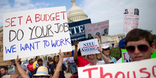 Oct. 4, 2013: Protestors hold signs during a during an event with the Democratic Progressive Caucus and furloughed federal employees on Capitol Hill.
