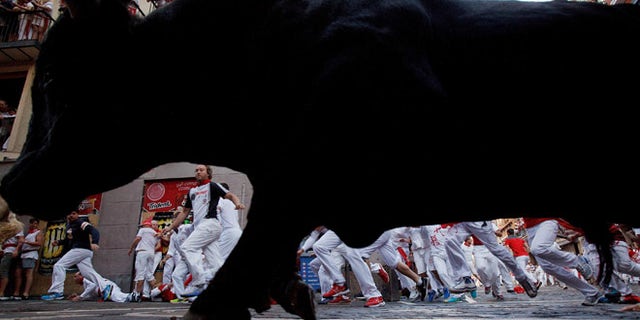 PAMPLONA, SPAIN - JULY 08: Revellers run with Cebada Gago's fighting bulls entering Estafeta Street during the third day of the San Fermin Running of the Bulls festival on July 8, 2016 in Pamplona, Spain. The annual Fiesta de San Fermin, made famous by the 1926 novel of US writer Ernest Hemmingway entitled 'The Sun Also Rises', involves the daily running of the bulls through the historic heart of Pamplona to the bull ring. (Photo by Pablo Blazquez Dominguez/Getty Images)