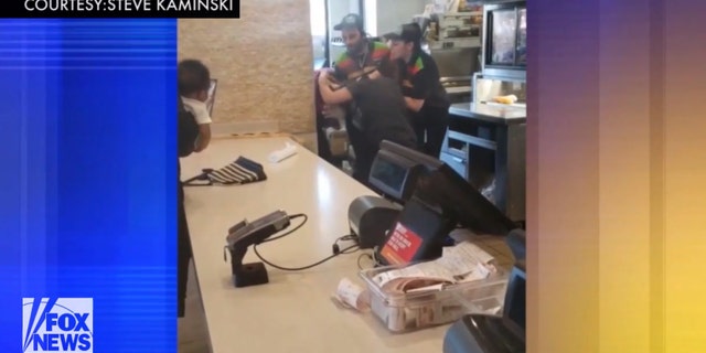 The women attempted to continue fighting after employees pried them apart.