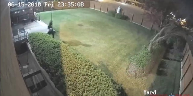 Image from surveillance footage showing man fleeing after burglarizing a church.
