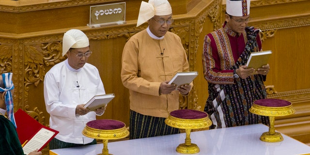 March 30, 2016: Lawmakers from right, Henry Van Hti Yu as seconnd vice president, Htin Kyaw as president and Myint Swe as first-vice president, take oaths during a ceremony in parliament in Naypyitaw, Burma.