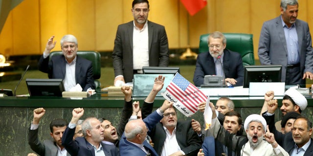 Iranian lawmakers are about to set a paper American flag on fire a day after President Trump announced he was withdrawing from the nuclear deal.