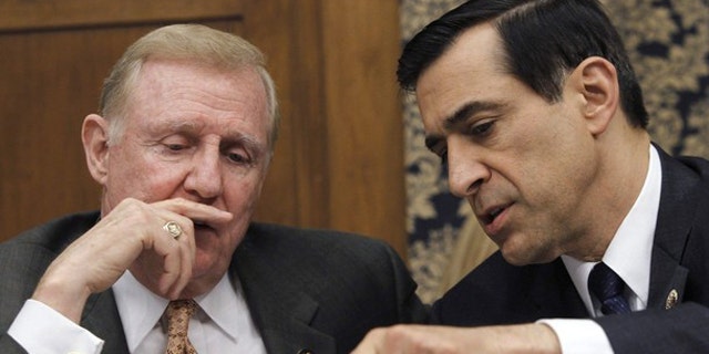Rep. Dan Burton (R-IN) (L) and Rep. Darrell Issa (R-CA) hold a discussion during a House Committee on Oversight and Government Reform hearing, February 24, 2010. (Reuters)