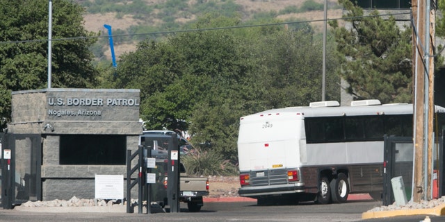 A bus carrying children arrives to a border patrol facility in Nogales, Ariz., Saturday, June 7, 2014.