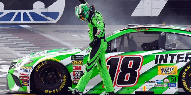 Kyle Busch (18) celebrates after winning a NASCAR Cup Series auto race in Fort Worth, Texas, Sunday, April 8, 2018. (AP Photo/Larry Papke)