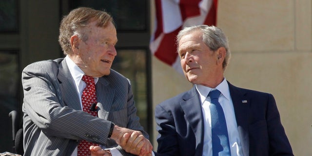 Former U.S. President George W. Bush (R) shakes hands with his father, former President George H.W. Bush, at the dedication of the George W. Bush Presidential Center on the campus of Southern Methodist University in Dallas, Texas April 25, 2013. REUTERS/Mike Stone (UNITED STATES - Tags: POLITICS TPX IMAGES OF THE DAY) - RTXYZSP