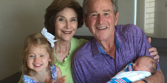 Aug 14, 2015: George W. Bush and his wife Laura hold their new granddaughter, Poppy Louise Hager. (The Bush Family)
