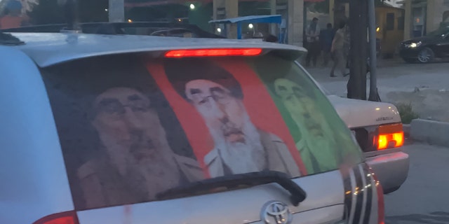 Supporters of Gulbuddin Hekmatyar display his image on their vehicles