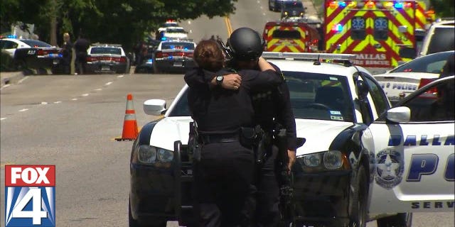 First responders hugging near the shooting scene.