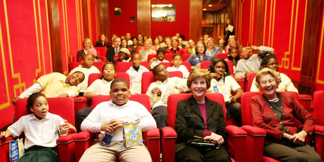 Students and their mentors from Everybody Wins! DC, a community-based mentoring program, join U.S. first lady Laura Bush (front, 2nd R) and her mother Jenna Welch (front R) to watch C.S. Lewis' "The Chronicles of Narnia: The Lion, The Witch, and The Wardrobe" in the White House Theater, December 2005.
