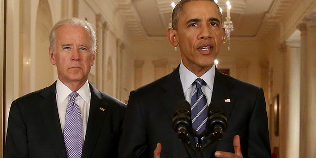 President Obama, standing with Vice President Biden, delivers remarks in the White House on July 14, 2015.