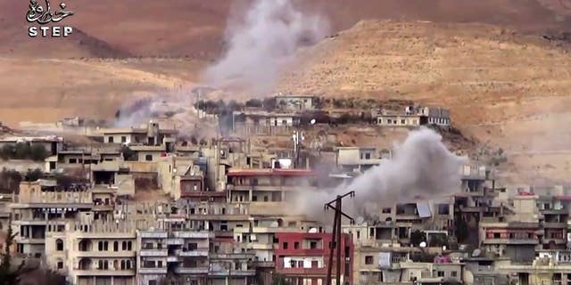 FILE - This file frame grab from video provided on Sunday, Dec. 25, 2016 by Step News Agency, a Syrian opposition media outlet that is consistent with independent AP reporting, shows smoke rise from the government forces shelling on Wadi Barada, northwest of Damascus, Syria. Opposition activists and Syria's state TV said on Friday, Jan. 13, 2017 that maintenance workers have arrived in the rebel-held valley near Damascus to fix the water facility there, ending a violent standoff that has dried out the capital for weeks. (Step News Agency, via AP, File)