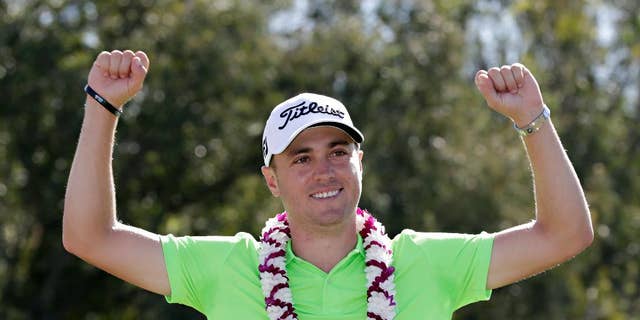 Justin Thomas celebrates after the final round of the Tournament of Champions golf event, Sunday, Jan. 8, 2017, at Kapalua Plantation Course in Kapalua, Hawaii. (AP Photo/Matt York)