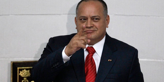 FILE - In this Jan. 5, 2013, file photo, National Assembly President Diosdado Cabello gestures before addressing the National Assembly in Caracas, Venezuela. Cabello said Tuesday, April 22, 2015, that he will file a lawsuit against the outlets that published reports in January saying his bodyguard had defected to the United States to testify that his former boss heads a drug ring of political and military officials. (AP Photo/Ariana Cubillos, File)