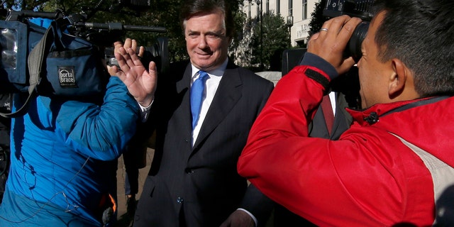 Paul Manafort makes his way through television cameras as he walks from Federal District Court in Washington, Monday, Oct. 30, 2017. Manafort, President Donald Trump's former campaign chairman, and Manafort's business associate Rick Gates have pleaded not guilty to felony charges of conspiracy against the United States and other counts. (AP Photo/Alex Brandon)