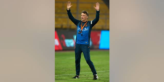 FILE - In this June 10, 2013,file photo Netherlands' coach Louis van Gaal gestures during practice, a day before a friendly soccer match against the Chinese national team at the Worker's Stadium in Beijing, China. Van Gaal, who will be replaced by Guus Hiddink after the tournament, has rebuilt the team to play more attractive attacking football. (AP Photo/Ng Han Guan, File)