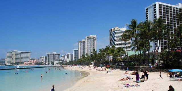 In this March 13, 2017, file photo, people relax on the beach in Waikiki in Honolulu. David, who described his hunt for a part-time home not far from Honolulu, explained that the house he found "is just the right size" for his extended family to be together.  