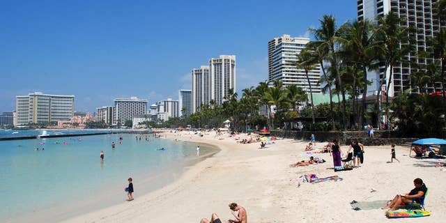 In this March 13, 2017, file photo, people relax on the beach in Waikiki in Honolulu. David, who described his hunt for a part-time home not far from Honolulu, explained that the house he found "is just the right size" for his extended family to be together.