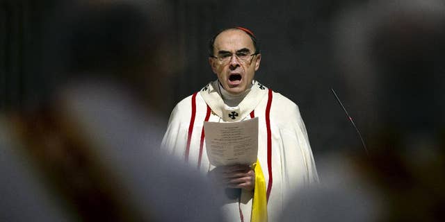 FILE - In this April 3, 2016 photo, French Cardinal Philippe Barbarin, Archbishop of Lyon, leads a mass for migrants, in Lyon, central France. The French Catholic Church announced Tuesday, April 12, 2016 the creation a new independent commission made up of secular experts to advice bishops and help them handling the sensitive cases of child sex abuses by priests, amid growing concerns over newly-revealed pedophilia cases, especially in the Lyon diocese run by cardinal Barbarin. (AP Photo/Laurent Cipriani, File)