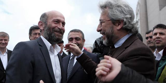 FILE - In this Friday, May 6, 2016 file photo, journalists Can Dundar, right, and Erdem Gul, Ankara Bureau Chief of Cumhuriyet newspaper, speak before the start of their trial, hours before the attack on Can Dundar outside city's main courthouse in Istanbul. Two opposition journalists went on trial in Turkey for a second time on Wednesday, Sept. 21, 2016 accused of aiding the movement led by U.S.-based cleric Fethullah Gulen that the government has branded a terror organization. (Can Erok, Cumhuriyet via AP, File) TURKEY OUT
