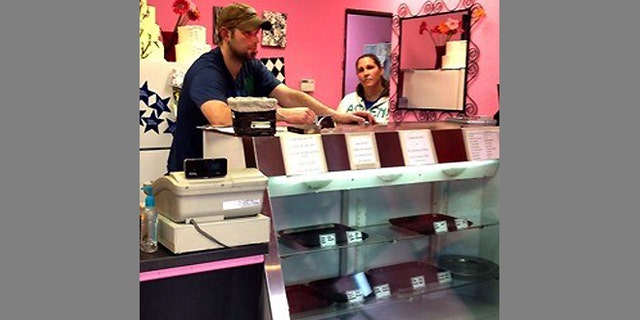 FILE - In this undated photograph Aaron Klein stands behind the counter of his Oregon bakery, Sweet Cakes by Melissa. Since this photo was taken the store has closed. The Kleins now operate their bakery business out of their home.