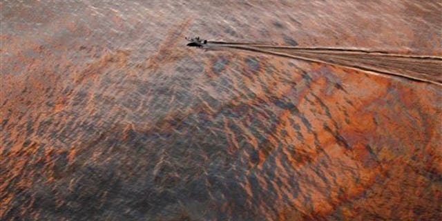 In this July 31, 2010 file photo, a boat motors through oil sheen from the Deepwater Horizon oil spill off East Grand Terre Island, where the Gulf of Mexico meets Barataria Bay, on the Louisiana coast, at sunset. A year after one of the worst environmental disasters in U.S. history, drilling rigs once again are probing the depths of the Gulf of Mexico for oil. But the catastrophic prospect of a spill in oil's next frontier -- the icy waters off Alaska's north coast -- has experts far more concerned. (AP/File)