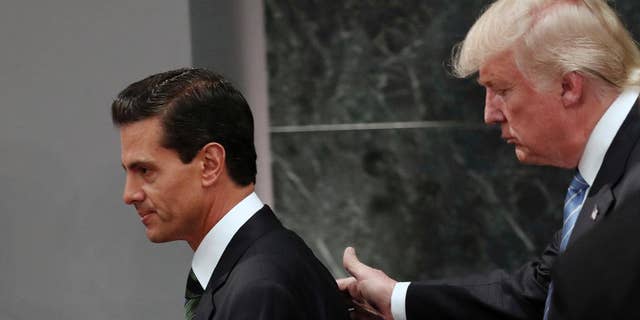 FILE - In this Aug. 31, 2016 file photo, Republican presidential nominee Donald Trump walks with Mexico President Enrique Pena Nieto at the end of their joint statement at Los Pinos, the presidential official residence, in Mexico City. President Donald Trump and Mexican President Enrique Pena Nieto spoke for an hour by phone Friday Jan. 27, 2017 amid rising tensions over the U.S. leader's plans for a southern border wall, administration officials said.(AP Photo/Dario Lopez-Mills, File)