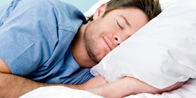 Man comfortably sleeping in his bed