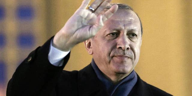 Turkey's President Recep Tayyip Erdogan gestures as he delivers a speech during a rally of supporters a day after the referendum, at his palace, in Ankara, Turkey, Monday, April 17, 2017. Turkey's main opposition party urged the country's electoral board Monday to cancel the results of a landmark referendum that granted sweeping new powers to Erdogan, citing what it called substantial voting irregularities. (AP Photo/Burhan Ozbilici)