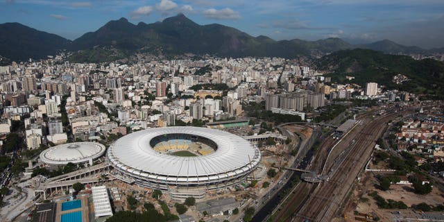 FILE - In this April 11, 2013 file photo, an aerial view shows the new rooftop of the Maracana Stadium, which is undergoing renovations in preparation for the 2013 Confederations Cup and 2014 World Cup, in Rio de Janeiro, Brazil. After almost three years of renovations, the Maracana Stadium is finally set to reopen in Brazil. The inauguration on Saturday, April 27, 2013 comes after a series of delays and amid widespread criticism related to overspending and the venue's privatization. (AP Photo/Felipe Dana, File)
