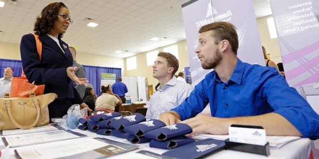 In this photo taken Wednesday, July 16, 2014, job seeker Staci Sudduth, left, talks to job recruiters Cameron Quin, center, and Jay Kington, right, at a Hiring Fair For Veterans in Fort Lauderdale, Fla. Payroll processor ADP reports how many jobs private employers added in July on Wednesday, July 30, 2014. (AP Photo/Alan Diaz)