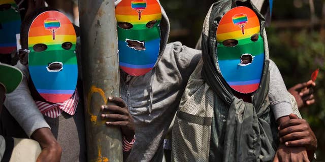 FILE - In this Monday, Feb. 10, 2014 file photo, Kenyan gays and lesbians and others supporting their cause wear masks to preserve their anonymity as they stage a rare protest. Human Rights Watch is urging an end to "forced anal examinations" with a report documenting them in eight countries, mostly in Africa, saying the practice is based on flawed ideas about supposedly proving homosexual conduct. (AP Photo/Ben Curtis, File)