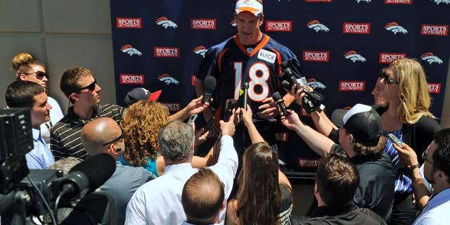 Denver Broncos quarterback Peyton Manning talks to the media following an NFL football organized team activity, Wednesday, May 28, 2014, in Englewood, Colo. (AP Photo/Jack Dempsey)
