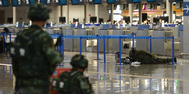 A demolition expert prepares to dismantle a suspected bomb in a closed off area after an explosion at Shanghai's Pudong airport Sunday.
