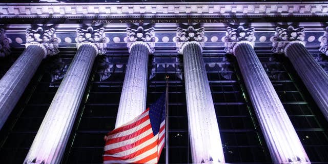 In this Oct. 8, 2014 photo, an American flag flies in front of the New York Stock Exchange in New York. U.S. stocks are plunging in early trading Wednesday, Oct. 15, 2014, as traders flee risky assets. (AP Photo/Mark Lennihan)