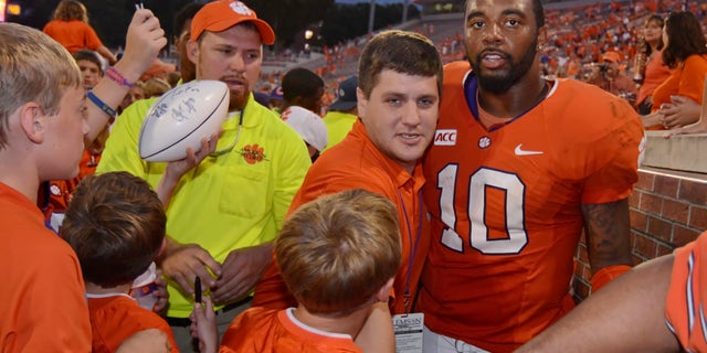 Clemson quarterback Tajh Boyd (10) is surrounded by fans while being escorted off of the field after defeating Boston College 24-14 in an NCAA college football game on Saturday, Oct. 12, 2013, at Memorial Stadium in Clemson, S.C. (AP Photo/ Richard Shiro)