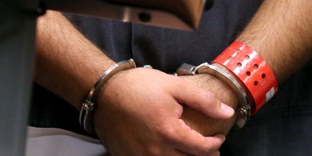 SANFORD, FL - NOVEMBER 19:  Detail of the handcuffed hands of George Zimmerman, the acquitted shooter in the death of Trayvon Martin, faces a Seminole circuit judge during a first-appearance hearing on charges including aggravated assault stemming from a fight with his girlfriend November 19, 2013 in Sanford, Florida. Zimmerman, 30, was arrested after police responded to a domestic disturbance call at a house. He was acquitted in July of all charges in the shooting death of unarmed, black teenager, Trayvon Martin.   (Photo by Joe Burbank-Pool/Getty Images)