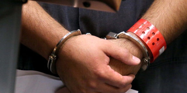 SANFORD, FL - NOVEMBER 19: Detail of the handcuffed hands of George Zimmerman, the acquitted shooter in the death of Trayvon Martin, faces a Seminole circuit judge during a first-appearance hearing on charges including aggravated assault stemming from a fight with his girlfriend November 19, 2013 in Sanford, Florida. Zimmerman, 30, was arrested after police responded to a domestic disturbance call at a house. He was acquitted in July of all charges in the shooting death of unarmed, black teenager, Trayvon Martin. (Photo by Joe Burbank-Pool/Getty Images)