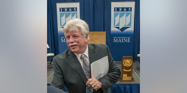 FILE - In this May 28, 2013 file photo, Dennis "Red" Gendron speaks to well-wishers after being introduced as the new men's hockey coach at the University of Maine, in Orono, Maine. Gendron has coached championship hockey teams in high school, college and the NHL. The hockey faithful are hoping he can now restore the luster to the University of Maine hockey program. (AP Photo/Michael C. York, File)